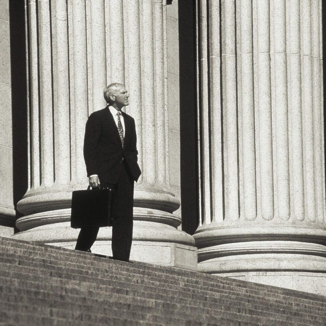 A man carrying a black suitcase