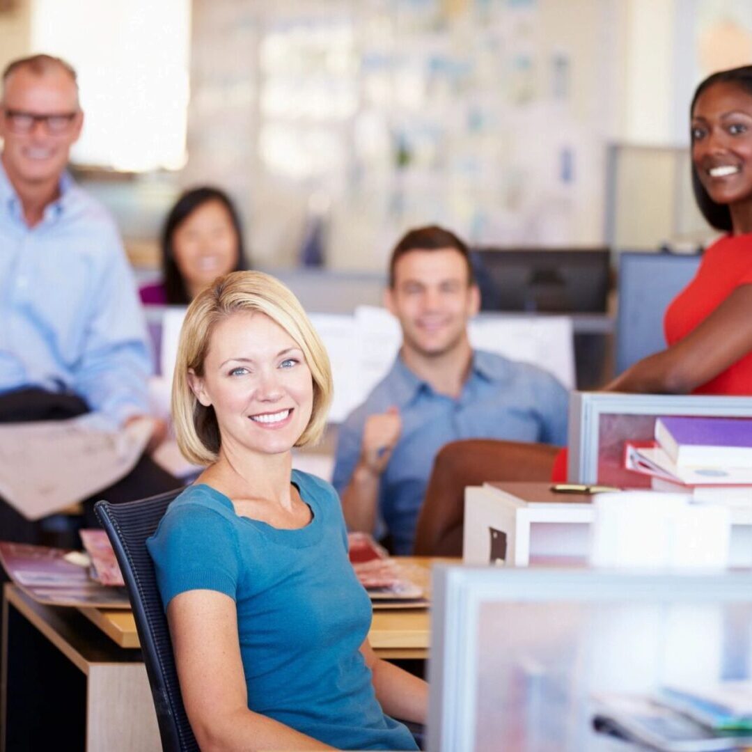 A group of people posing for a picture at an office